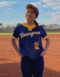 A girl in blue and yellow baseball uniform on the field.