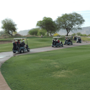 A group of people riding carts down the road.