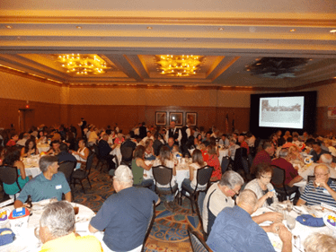 A large group of people sitting at tables.