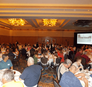 A large group of people sitting at tables.